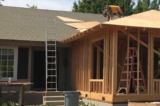 A new home addition under construction with a ladder